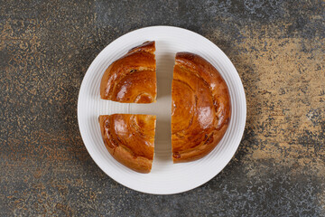 Sliced fresh pastry on white plate