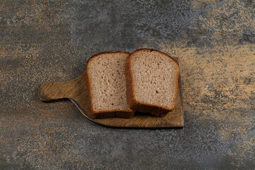 Black toast bread on wooden board