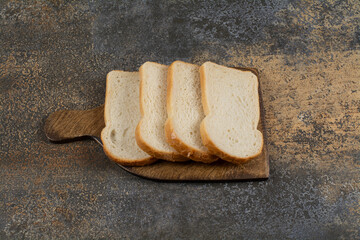 Fresh white sliced bread on wooden board