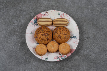 Biscuits and cookie on the plate, on the marble background