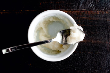 Bloomed Gelatin Powder in a Ramekin Dish: Gelatin powder mixed with water in a small ceramic bowl
