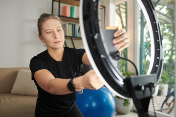 Woman Setting Filming Equipment