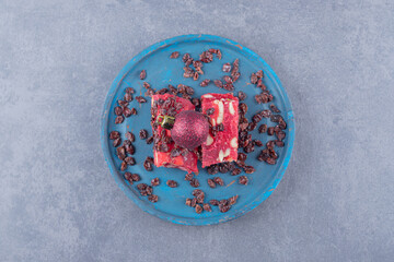 Fototapeta na wymiar Turkish delight - lokum or rahat lokum with pistachios on blue plate over grey