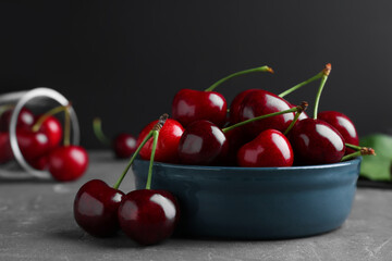 Fresh ripe cherries on grey table, closeup