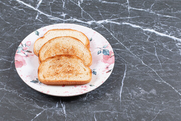 Three toasts arranged in plate, on the marble background