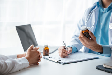 Close up of doctor's hands is explaining and advising about using pills medicine and treatment to patient.