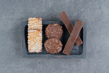 Cookies with chocolate round cookies on a dark board