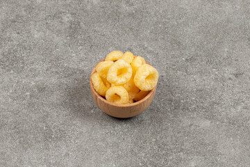 Delicious crunchy snack in wooden bowl