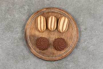 Tasty cocoa cookies on wooden board
