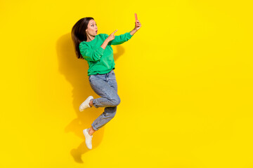 Fototapeta na wymiar Full length portrait of impressed person jump point finger telephone isolated on yellow color background