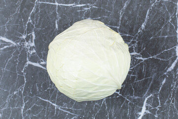 Tasty white cabbage on marble background