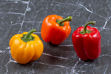 Fresh colorful peppers on marble background