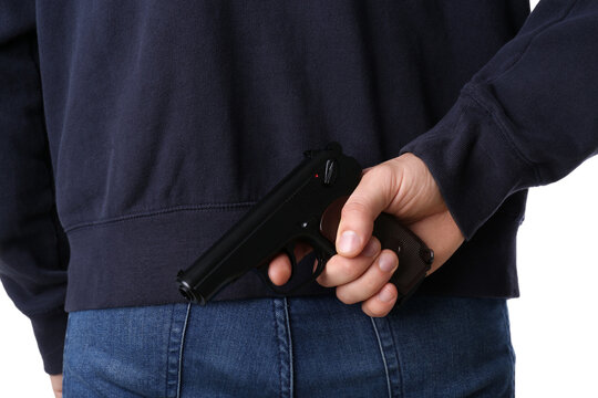 Man hiding gun behind his back, closeup view