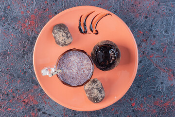 Fresh cookie and homemade milk shake on orange plate