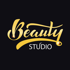 Beauty studio. Digital hand lettering. Logo for company cosmetic business packaging fashion. Golden letters with sparkles on the dark background. Fashion luxury logotype emblem. Beauty salon.