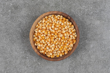 Pile of dried corns in wooden bowl