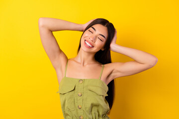 Photo of adorable sweet young lady wear green outfit arms head closed eyes isolated yellow color background