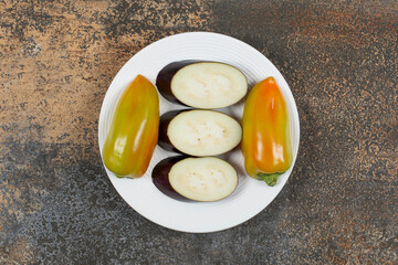 Ready to cook vegetable on the plate, on the marble background