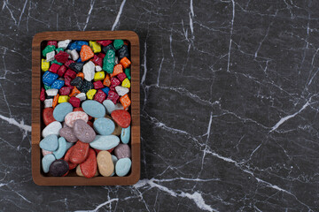 Different kinds of chocolates on the board , on the marble background