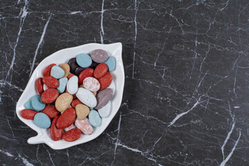 A small portion candies, on the marble background