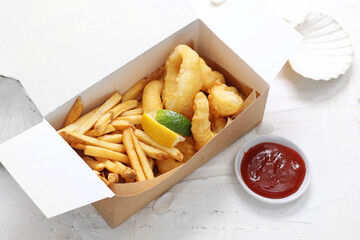 Deep fried calamari, squid rings in tempura and fries, in a take-away carton box, on a white...