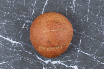 Delectable bread loaf, on the marble background