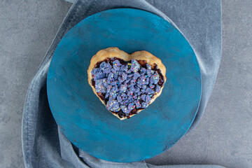 A blue plate with sweet heart shaped pastry
