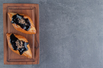 Delicious sweet triangle pastry on a wooden board