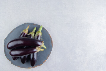 Tasty eggplants on a board on the white background