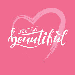 You are beautiful. Digital hand lettering.  white letters on the pink textured heart. Women's trendy calligraphy. Stylish gentle illustration. Fashion magazine cover. Innuendo color. Logo. 