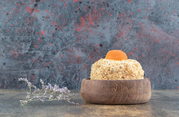 A wooden bowl with delicious sweet cake