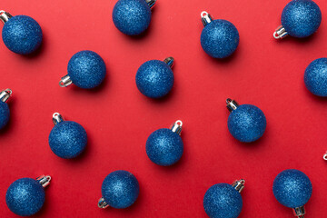 Christmas balls on color background, top view