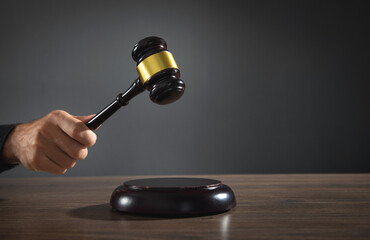 Male judge in a courtroom striking the gavel. © andranik123