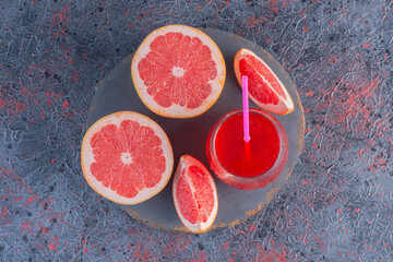 Grapefruit lemonade and cola glass with ice cubes and droplets on wooden board