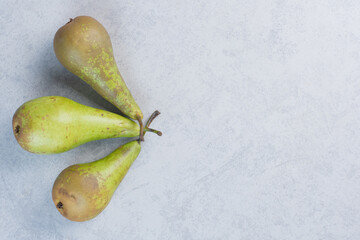 Fresh organic green pears on grey background