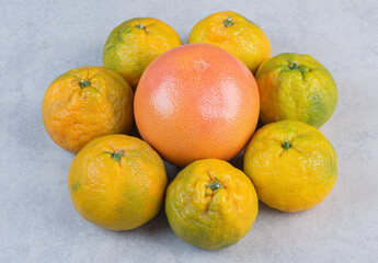Organic Tangerines (oranges, clementines, citrus fruits) over grey background