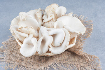 Basket full of oyster mushroom on sack