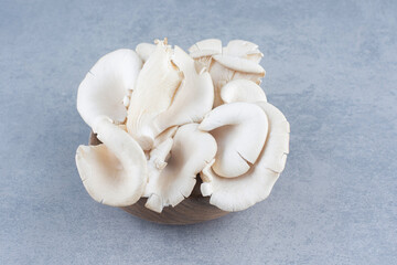 Fototapeta na wymiar Bowl of delicious organic oyster mushrooms on gray background