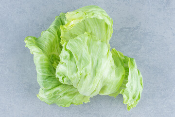 Fresh organic lettuce leaves on grey background