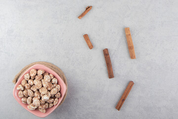 Cinnamon and a bowl of cookie on the marble background