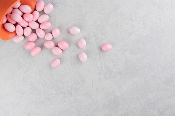 Gums spill out of a bowl, on the marble background