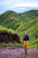 Naklejka premium woman in hiking boots watching the view from the top of the mountain in costa rica, cerro pelado; brave hiker girl enjoying the view from the top after a hard hike