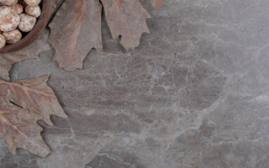  Flavorful confectionery and leaves , on the marble background