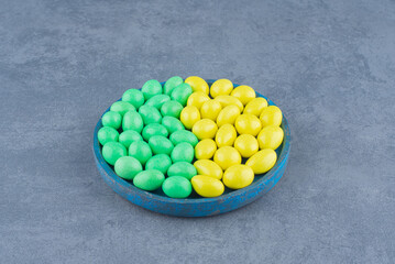 Delectable gums in the bowl, on the marble background