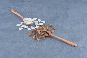 Two spoons of kernels, on the marble background