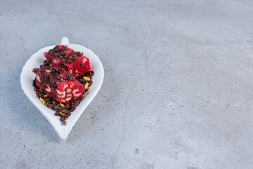 A small platter with flavored and colored Turkish delights on marble background