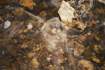 Crystal clear water top view. Environmental care concept. River underwater stones 