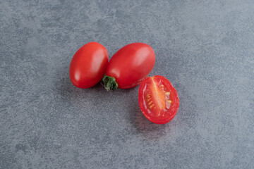 Many of red cherry tomatoes on a marble background