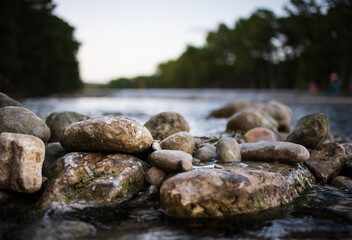 A close up of a rock sitting in a river