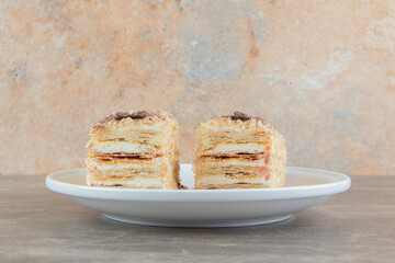Slices of napoleon cake on white plate